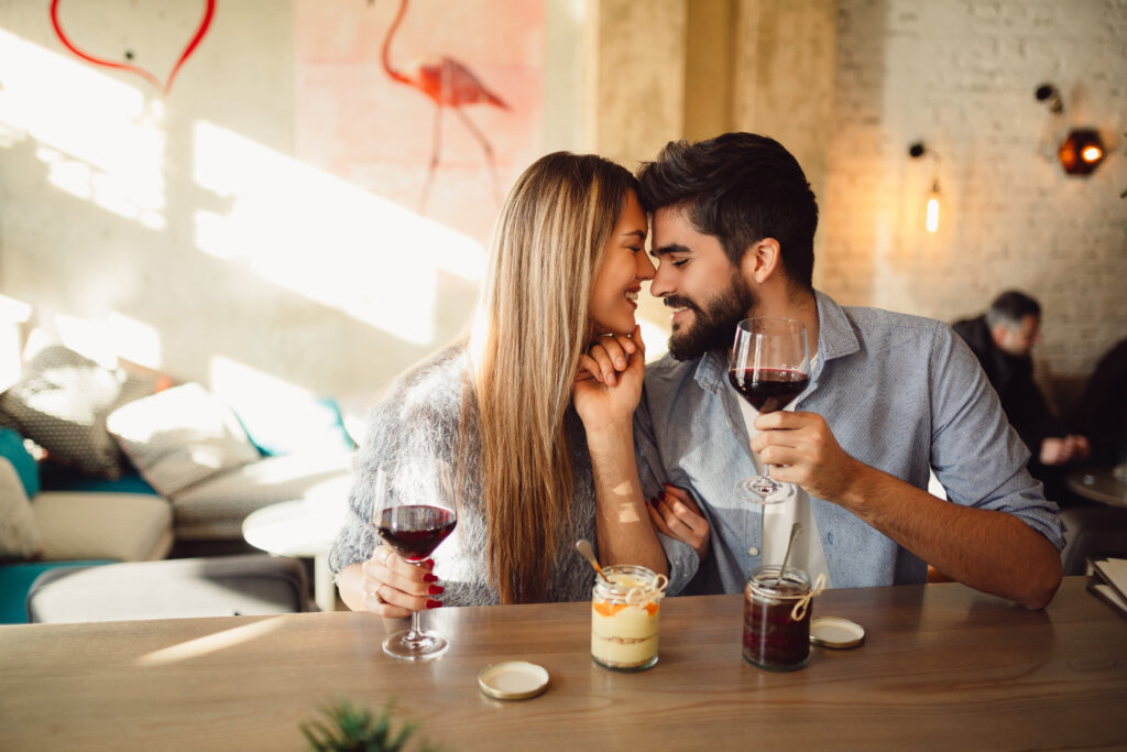 A couple in an exciting relationship with a glass of wine